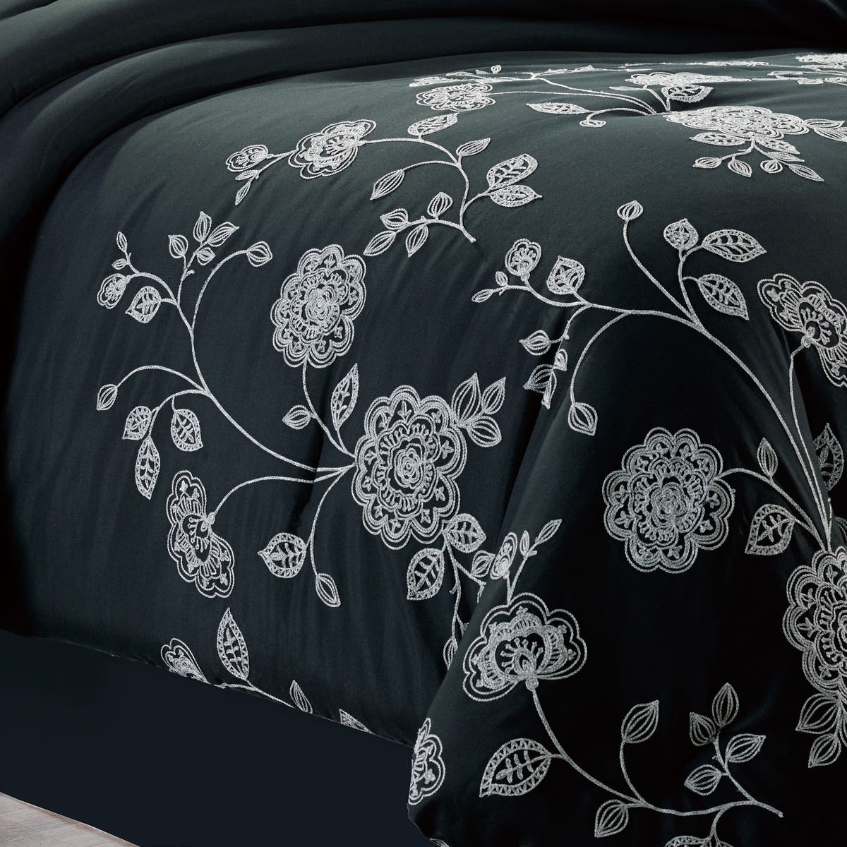 7-Piece Elegant Black and White Floral Embroidered Comforter Set, shown in a bedroom setting