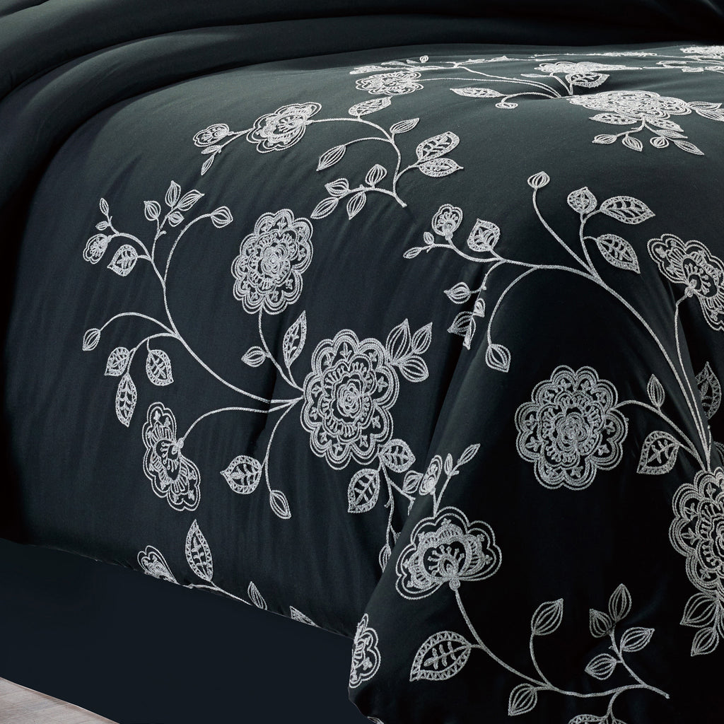 7-Piece Elegant Black and White Floral Embroidered Comforter Set, shown in a bedroom setting
