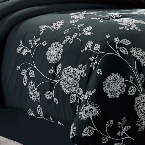 7-Piece Elegant Black and White Floral Embroidered Comforter Set, shown in a bedroom setting