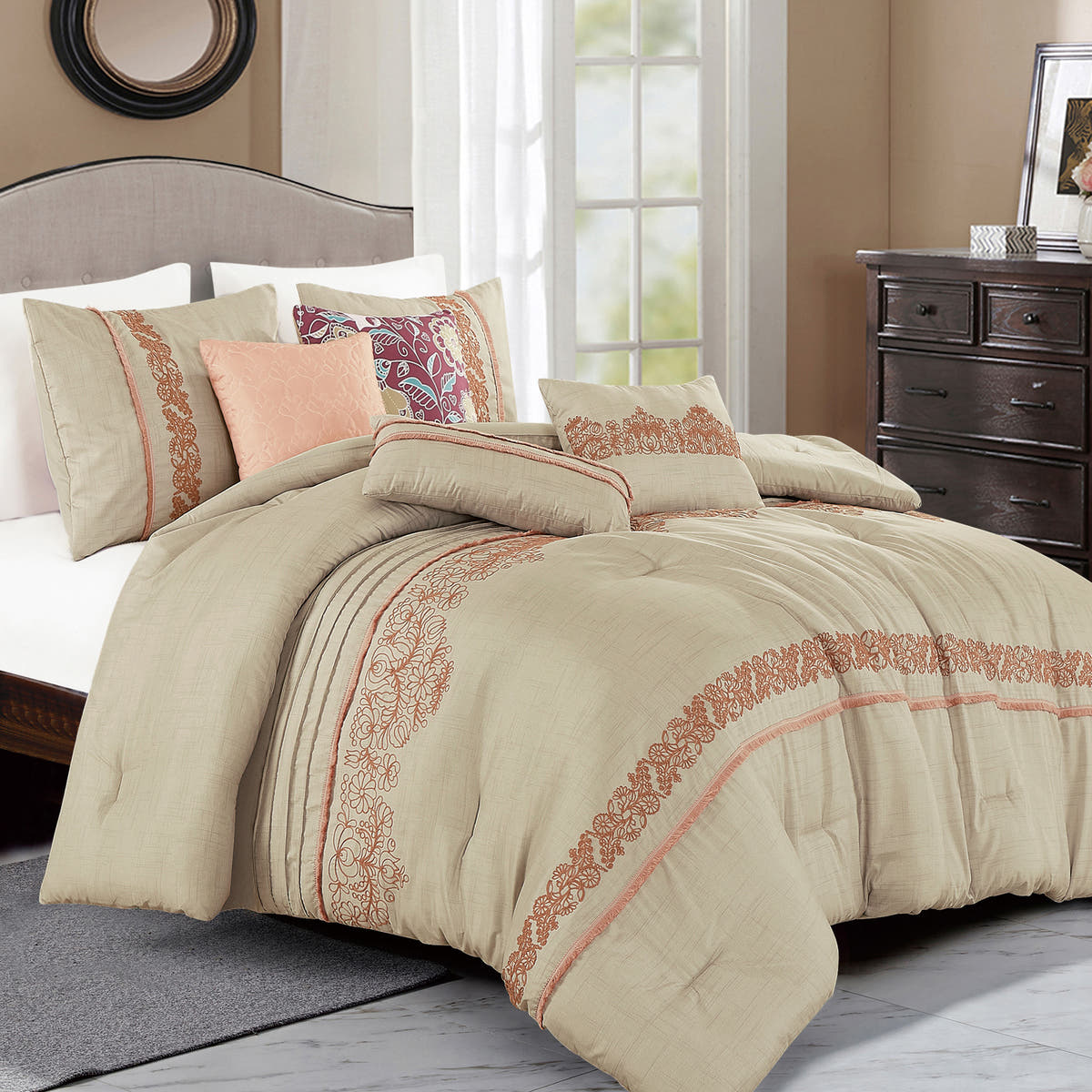 Beige floral embroidered 7-piece comforter set arranged on a bed