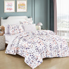 Modern Botanical Purple and Pink 7-Piece Complete Bedding Ensemble, styled on a made bed