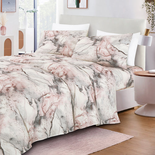 Blush & Grey Marble sheet set on a bed